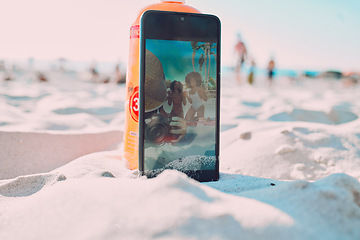 Image showing Phone, sand and friends taking a picture on the beach while on a summer vacation together. Travel, fun and women with freedom taking a selfie on smartphone while on seaside holiday adventure by ocean