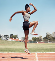 Image showing Fitness, jump or black woman runner on a race track in training, cardio workout or sports exercise in summer. Jumping, running and healthy African girl sprinter on a mission for goals in a stadium