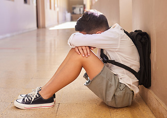 Image showing Anxiety, school and sad student bullying victim feeling depression, lost or stressed in hallway or corridor floor. Child, depressed boy or lonely male learner crying alone with abuse trauma or fear