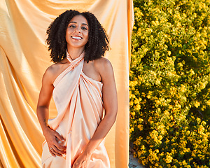 Image showing Beauty, fashion and portrait of black woman in garden on outdoor shoot with silk fabric backdrop and plants in summer sun. Elegance, glamour and happy woman with afro, smile and nature in background.