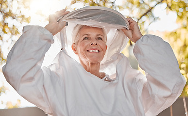 Image showing Happy, beekeeper and woman in nature for honey collection, monitor beehive health or check backyard environment. Smile, agriculture and senior apiarist in safety gear ready to start garden inspection