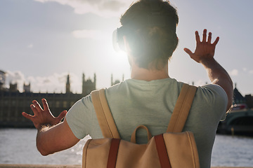 Image showing Vr, 3d and back of man in city exploring metaverse, cyber ai or future virtual world. Virtual reality, digital headset and male in street playing software video games, watching movie or web travel.