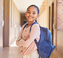 Image showing Backpack, happy and portrait of a girl at school in the hallway for education, scholarship and learning. Happiness, study and child student with smile standing at academy with bag for back to school.
