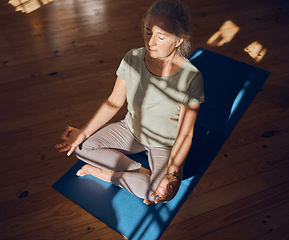 Image showing Meditation, yoga or senior woman in pilates lotus pose for wellness, zen energy or chakra training top view on floor. Mindset, exercise or elderly for freedom, peace or health workout in her house