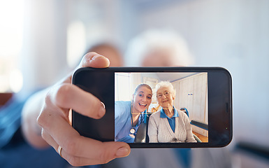 Image showing Phone, nurse and happy old woman take a selfie on screen after consulting with medical doctor. Photo, caregiver and healthy senior person in retirement take pictures for social media in nursing home