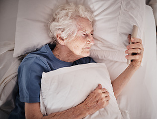 Image showing Bad vision, senior woman and phone on bed in bedroom home texting, social media or internet browsing. Blurred eyesight, retired and elderly female with smartphone squinting and trying to read message