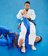 Image showing Karate, fight and top view for martial arts sports competiotion or personal trainer, coach and mma fighting workout. Taekwondo training, fitness exercise teacher and wrestling challenge on gym floor