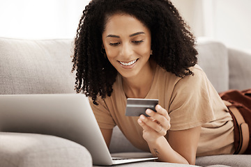 Image showing Laptop, credit card and woman on a sofa for online shopping, e commerce and payment in a living room, happy and smile. Ecommerce, black woman and online subscription upgrade, buying and shopping