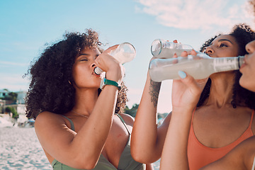 Image showing Beach, friends and African women drink bottle of liquid cold drink to relax on Summer vacation in Nigeria. Nature travel, black woman or thirsty bikini girl drinking lemonade on holiday adventure