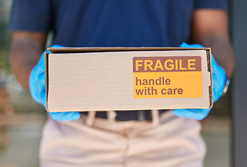 Image showing Courier, delivery and box with label for fragile goods, handle with care and shipping closeup, safety and protection. Retail, ecommerce and online shopping, distribution of package and postal worker.