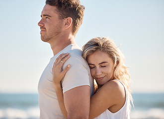 Image showing Couple, hug and love bonding on beach by ocean or sea in trust, support or security on summer holiday in tropical Bali travel location. Smile, happy or embrace for man and woman on nature honeymoon