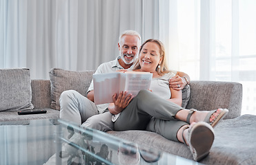 Image showing Senior couple reading book on sofa together enjoying weekend, freedom and retirement at home. Love, relaxation and mature man and woman read novel bonding, smiling and sitting on couch in living room