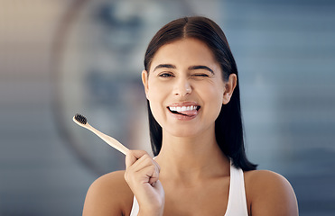 Image showing Cleaning, wooden toothbrush and woman in bathroom with cute expression on face ready for brushing teeth. Dentistry, oral healthcare and girl with natural, organic and eco friendly dental care product