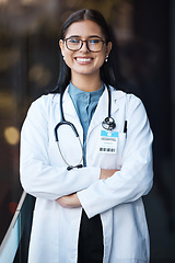 Image showing Healthcare, doctor and portrait of woman with smile and glasses in hospital lobby on happy mission to help. Proud female leader in medical field with vision, trust and leadership at clinic in India.