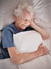 Image showing Relax, bedroom and old woman sleeping in peace resting in a house or home dreaming with a soft pillow in hand. Bedding, healthy grandmother or tired elderly person in retirement enjoys napping alone