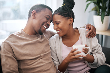 Image showing Love, coffee and couple relax on a sofa, talking and embrace in the morning in their home. Black couple, man and woman enjoy tea on couch, bond and share sweet conversation in a living room together