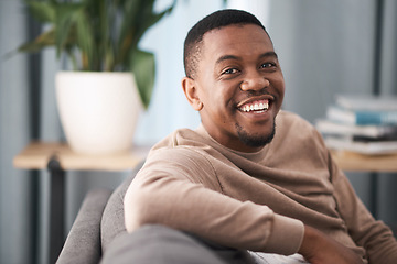 Image showing Face, smile and portrait of a black man relax in a living room at a house on a holiday, break or weekend. Happiness, calm and young male sitting alone in a lounge in home or apartment relaxing