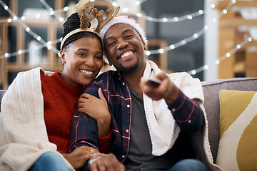 Image showing Watching tv, couple and relax on a sofa for christmas show, movie or film in living room in a home. Love, tv and man with woman portrait on couch for festive celebration tv show, channel and surfing