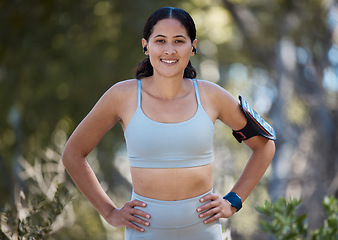 Image showing Portrait, runner and happy woman, arm band and earphones of music, motivation or fitness in nature, sports and cardio. Young athlete, healthy lifestyle and park training, exercise energy and wellness