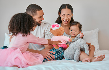 Image showing Family, morning and children on bed bonding with teddy bear for happiness, care and togetherness. Happy family, relax and siblings play together in bedroom with smile of baby, mother and dad.