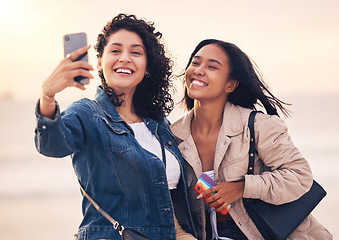 Image showing Black woman, friends and selfie at beach for sunset, bonding and summer happiness after work together. Women, smartphone and happy photo for social media, summer and ocean in dusk sunshine with smile