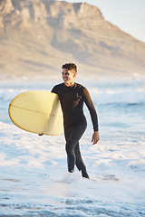 Image showing Surfing sports and man walking from ocean with smile, surfboard in hand and happiness in summer. Nature, water sports and male surfer on beach shore after fitness, exercise and cardio for wellness