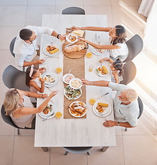 Image showing Family, food and lunch with love and care at the dining room table to eat and drink. Group, grandparents and parents with kids eating a delicious meal in a family home with a happy family in top view