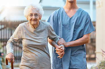 Image showing Elderly, woman and nursing home, caregiver and holding hands with healthcare for the old and support. Rehabilitation, help with care portrait and physical therapy with nurse and patient outdoor.