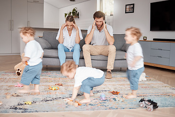Image showing Parents, stress and busy with an adhd child running around a home living room with energy or motion blur. Family children and headache with a hyperactive kid in a lounge with a stressed mom and dad