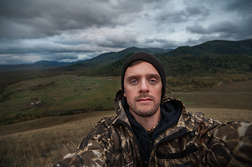 Image showing Caucasian man in the mountain making selfie