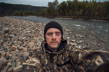 Image showing Caucasian man in the mountain making selfie