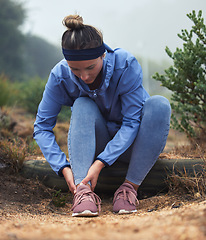 Image showing Tired, woman runner with leg pain and ankle injury from an active running marathon race training. Cardio fitness run workout, outdoor exercise and girl sports athlete rest on ground outside in nature