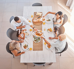 Image showing Family, lunch and food at the table with big family bonding, sharing and eating together at the dining table. Meal, top view and family home with a mother, father and grandparents and kids eat