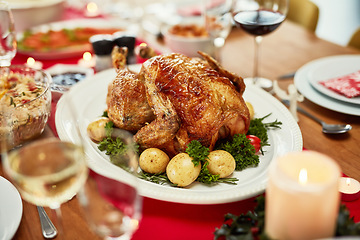 Image showing Thanksgiving, turkey and food with a meal on a dining room table for tradition in an empty room. Christmas, chicken and dinner of a place setting for a celebration even in a home or house closeup