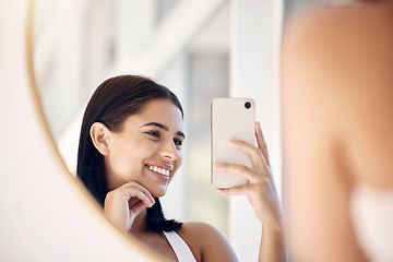 Image showing Phone, happy and selfie of woman in bathroom with smile for natural social media beauty in mirror. Reflection, happiness and skincare of wellness influencer girl with smartphone in the morning.