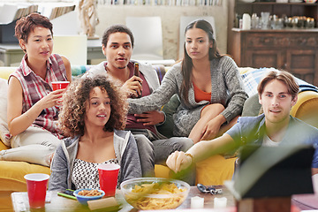 Image showing Snacks, living room and friends with a movie to watch together for entertainment in modern house. Television, fun and group of people streaming show online while relaxing on a couch in lounge at home