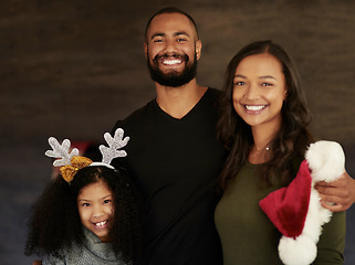 Image showing Christmas, hug and portrait of a family with love, care and smile during holiday celebration in their house. Affection, happiness and girl with mother and father to celebrate xmas in their home