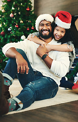 Image showing Father, child portrait, hug and Christmas holiday celebration, together and happy with smile at home. Christmas tree, decoration and festive, Mexican man and girl celebrate with love and care.