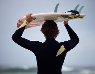 Image showing Surfer, surfboard and surfing ocean on waves for fitness exercise, leisure and water sport training exercise. Beach surf, man in wetsuit and fun sea freedom workout in Australia for summer wellness