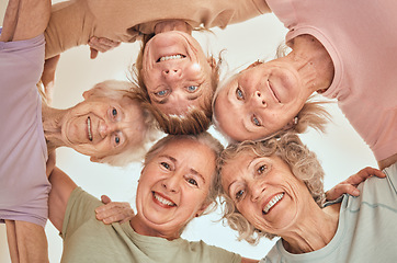 Image showing Fitness, happy and elderly friends in a circle for support, trust and team building in a wellness class below view. Partnership, smile and senior women in a huddle with motivation, health or hope