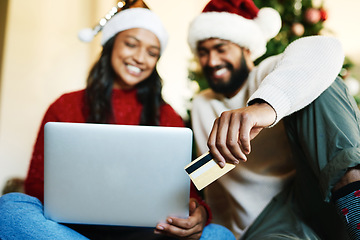 Image showing Laptop, credit card and couple online shopping on Christmas day in home living room. Xmas holiday, fintech and happy man and woman on computer, internet shop or virtual store buying gifts or presents