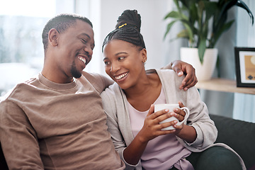 Image showing Coffee, relax and black couple on sofa in home living room, bonding and talking. Love, tea and romantic man and woman speaking, discussion or conversation on couch in lounge or enjoying time together