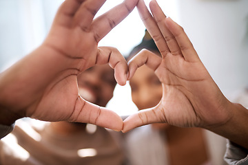 Image showing Love, heart hands and happy black couple excited for future in new home with support, trust and commitment. Romance, heart hands with black man and black woman relax on honeymoon together.