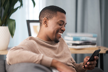 Image showing Happy black man, smartphone and relax in home, living room sofa and typing online, social media notification and download web connection. Young african guy, mobile app game and 5g internet technology