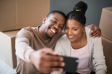 Image showing Phone, couple and selfie while moving in to home, real estate or apartment, happy and proud on a floor. New house, property and man with woman on a living floor for picture, moment and bonding