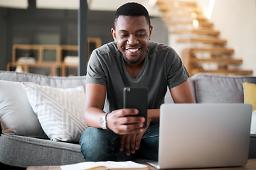 Image showing Laptop, phone and man on sofa for remote work, internet and search while working on freelance project. Freelancer, text and computer writing by designer guy searching for creative idea, tips and plan