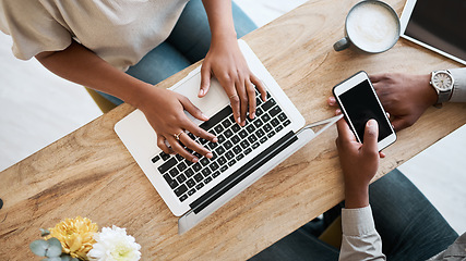 Image showing Hands, laptop and phone with a coffee shop business team working together from above. Collaboration, technology and remote work with a black man and woman employee at wok in an internet cafe