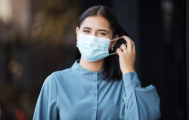 Image showing Woman, covid and face mask removing for end of pandemic, freedom in healthcare safety on mockup. Portrait of female taking off protective mask in relief for corona virus ending on bokeh background