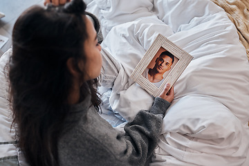 Image showing Woman, sad and photo for widow on bed after death, funeral or loss of husband, partner or man. Grief depression, girl and picture memory of love, marriage or anxiety in home bedroom for mental health
