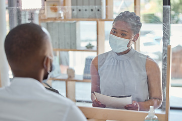 Image showing Office, face mask and business people in meeting with regulations during covid pandemic. Social distance, corporate and professional African employees talking with documents or paperwork in workplace
